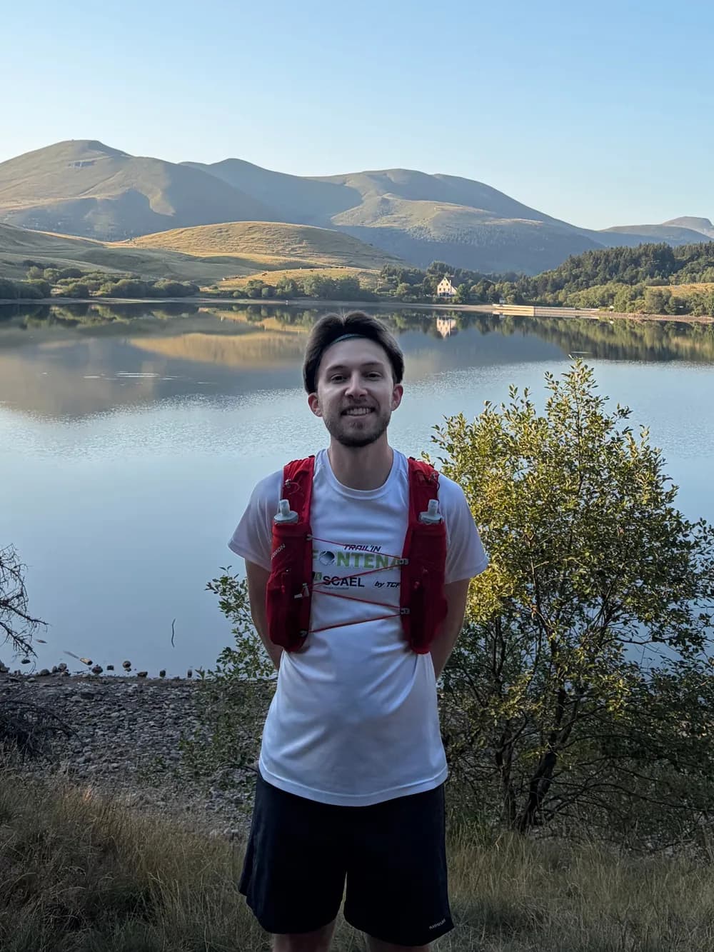 Axel Blanchard en tenue de trail, devant un lac de montagne